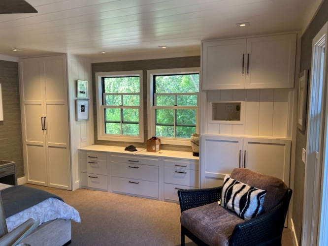 Painted white solid wood closet system in a customer's bedroom